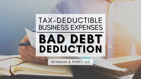 'Tax-Deductible Business Expenses: Bad Debt Deduction | Seymour & Perry, LLC' overlays a man holding a pen and paper at a laptop computer with an open notebook nearby.