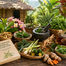 Basketed herbs, roots, limes, and mortar on a rustic table beside a Philippine Herbal Medicine book in a lush tropical garden