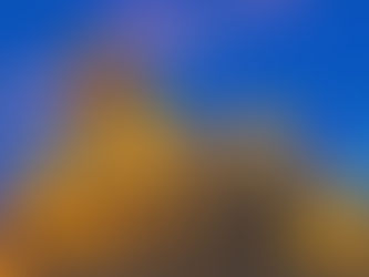 Illuminated cathedral at dusk with a prominent dome and tower, under a vibrant blue sky. Warm golden lights enhance the historic architecture.