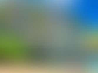 Puerto Princesa, Tourists in life vests walk along a sandy beach with a colorful boat on turquoise water. Tall cliffs with greenery rise under a blue sky.