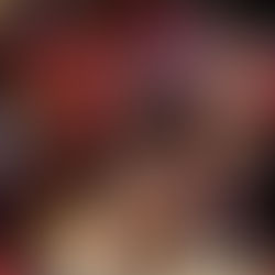 Colorful woven bags hang in a market stall. The bags feature red, purple, and natural hues with intricate patterns, evoking a vibrant mood.