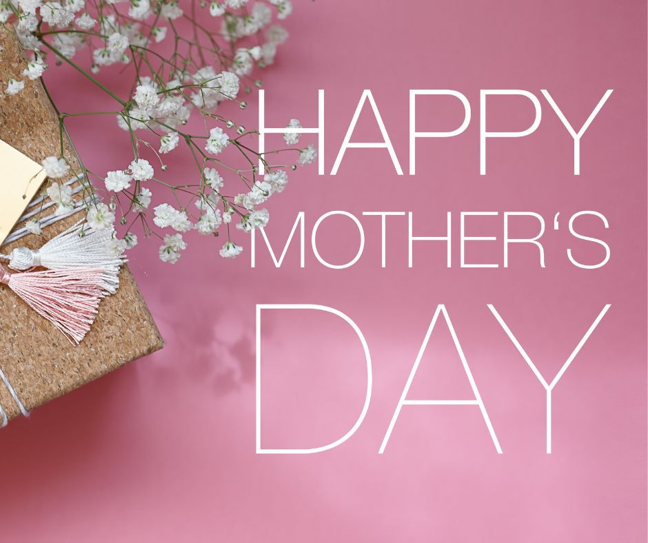 Gift with pink and white tassels and white flowers on a pink background. Text reads "HAPPY MOTHER'S DAY" in white.
