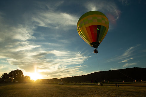 event_hot_air_balloon-ascending-golden-sunset-landscape.jpg
