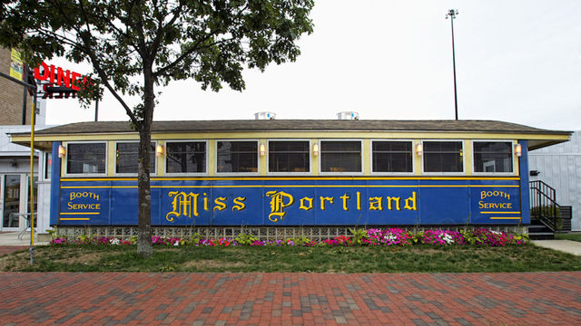 full exterior of the blue-and-yellow diner car