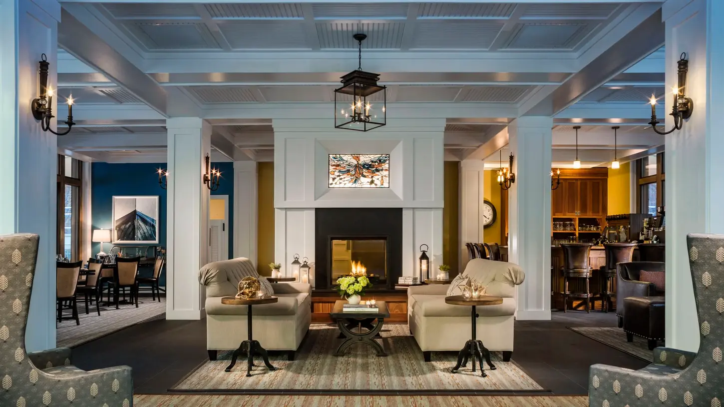 Sophisticated interior lounge at Inn at Diamond Cove with comfortable seating, grand fireplace, and refined historic details.