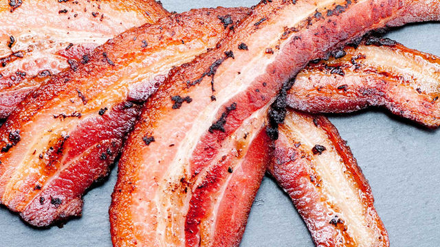 Close-up of perfectly cooked crispy bacon strips served as a classic breakfast accompaniment at The Classic Diner.