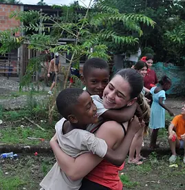 Voluntours Colombia Waves and Environment Care Nuqui - volunteers and children.webp