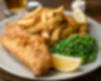 Fish and chips with peas and lemon