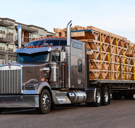 Flatbed truck on the road coordinated through 24/7 dispatch support