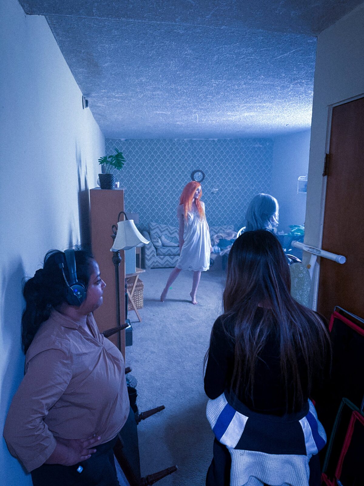 Crew watching Venus on the apartment set from the hallway