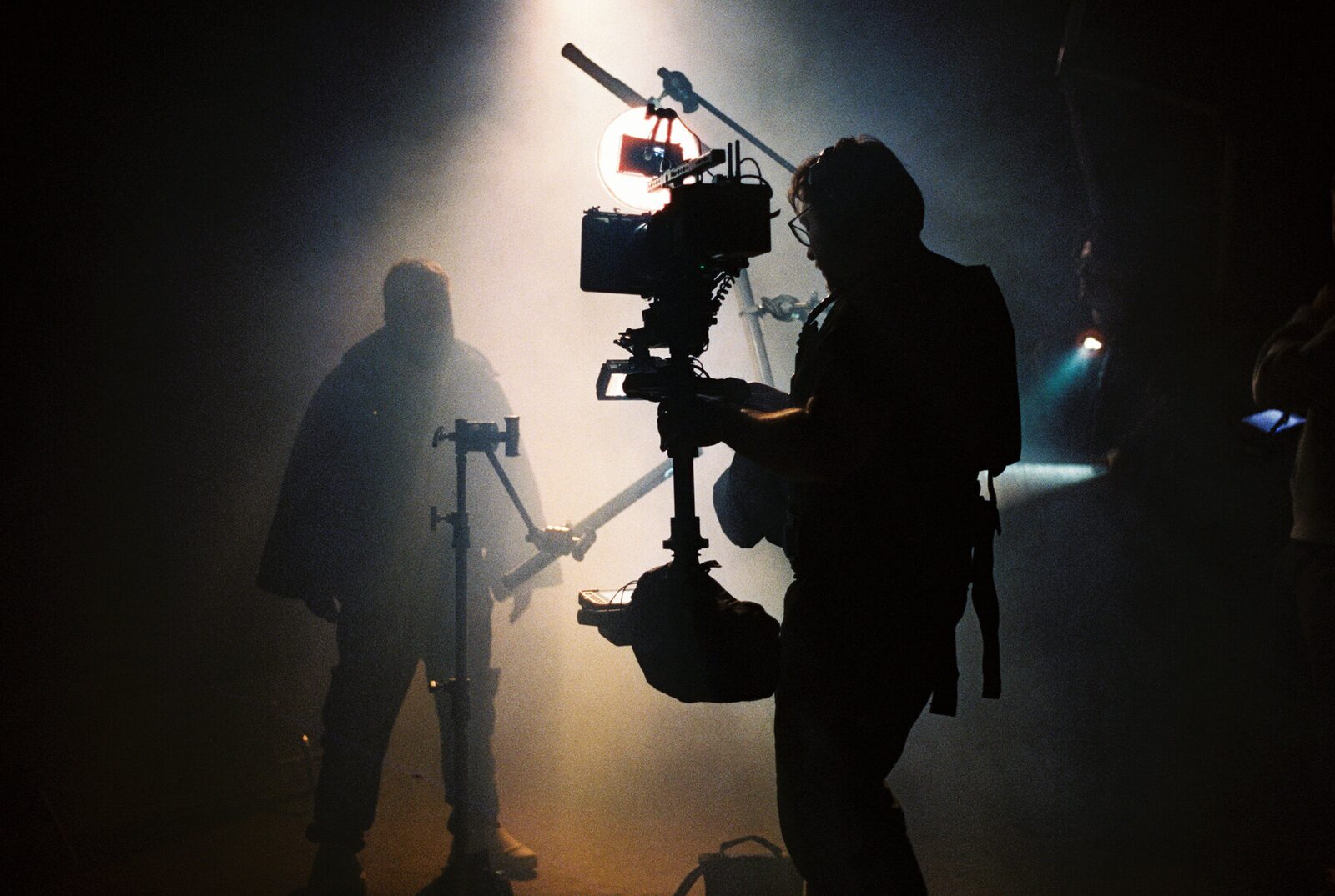 Two silhouettes in fog with a camera rig