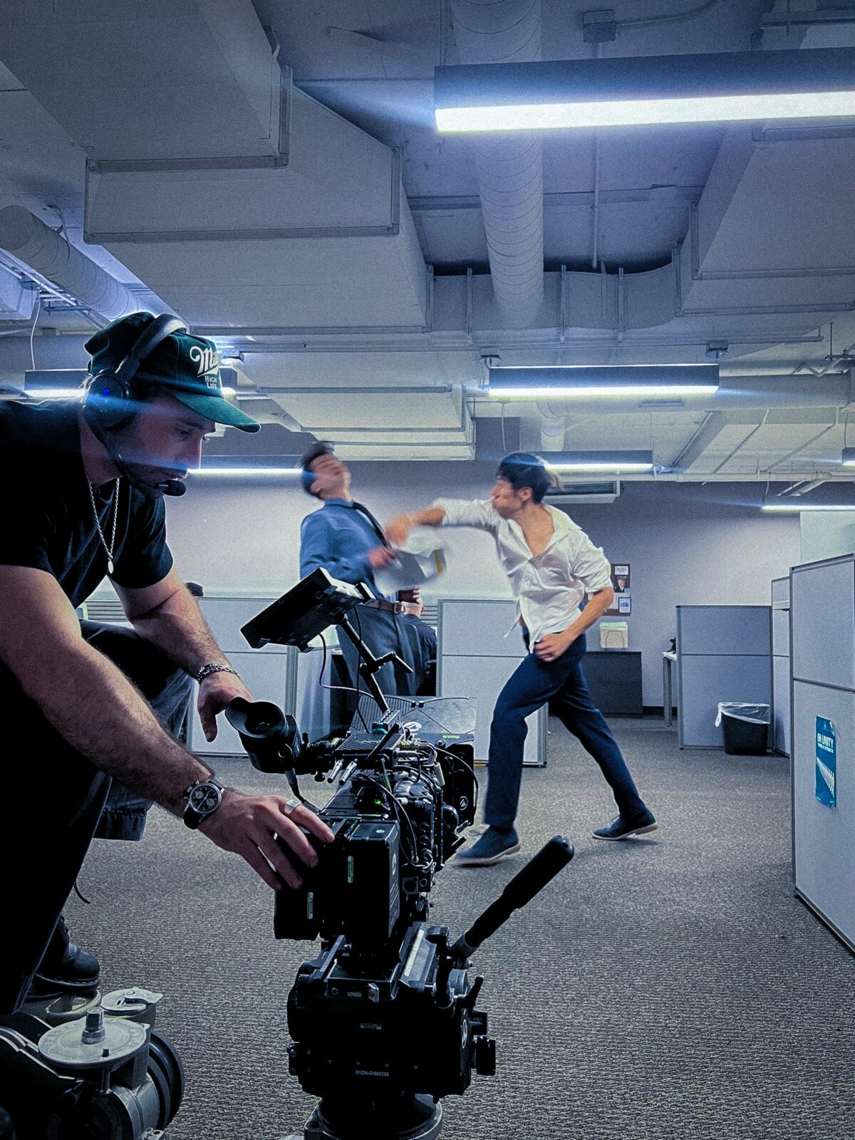 Elias at the camera as a fight plays out across the office set