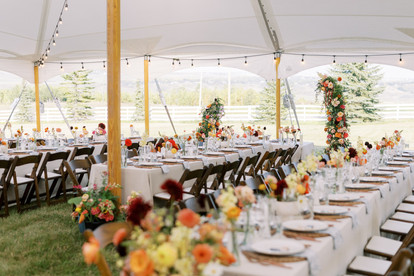 Tent wedding fall florals long tables with bud vases