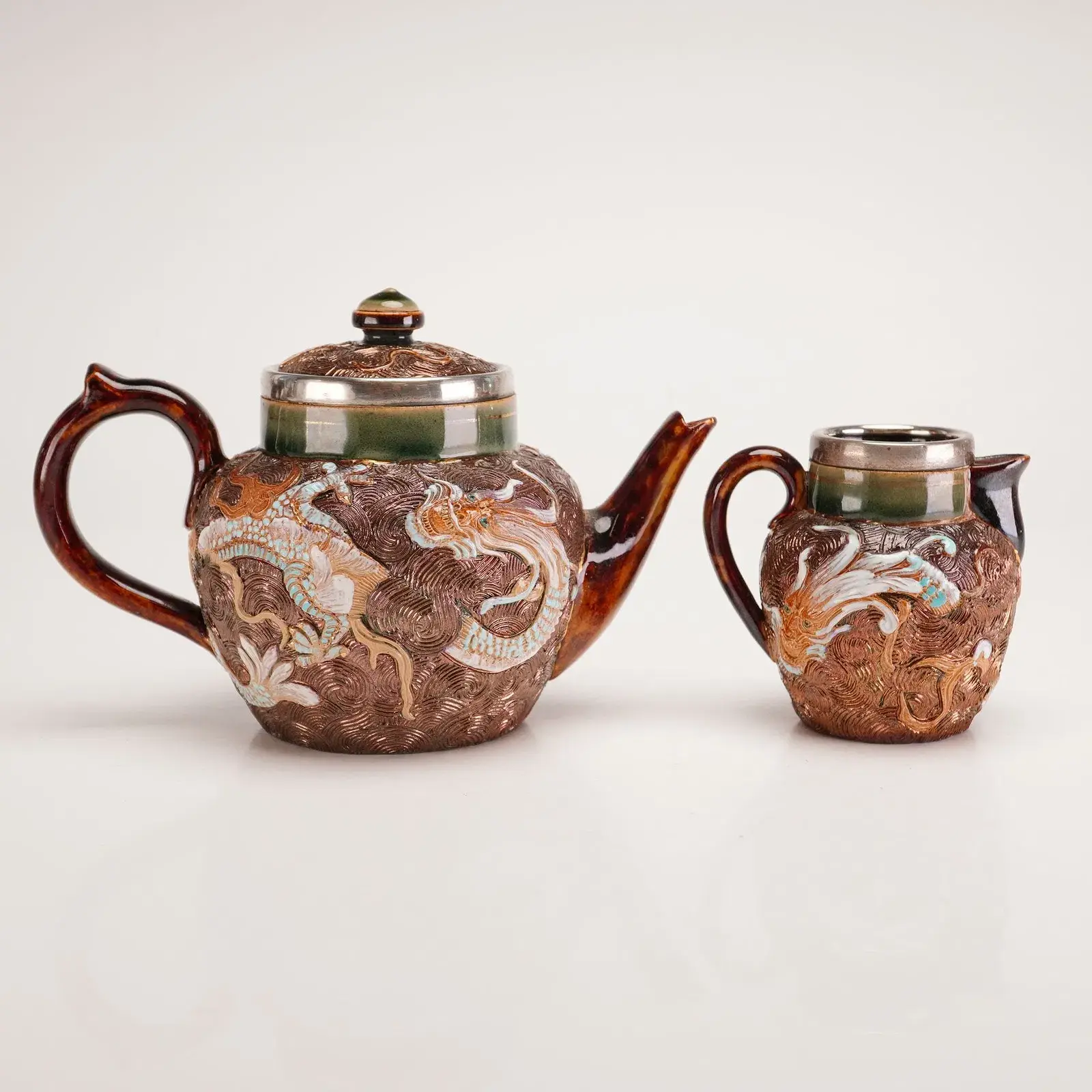 Two Doulton Lambeth Sterling Silver Mounted Stoneware Tea Wares, Dragon Pattern