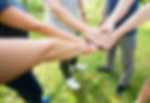 Image of a group of people with their hands together