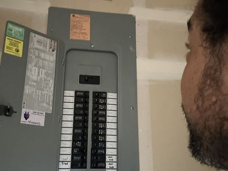 Problem Solved Electric, electrician checking a breaker panel in North Idaho.