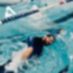 Eye-level view of a swimmer in a lane performing a stroke drill