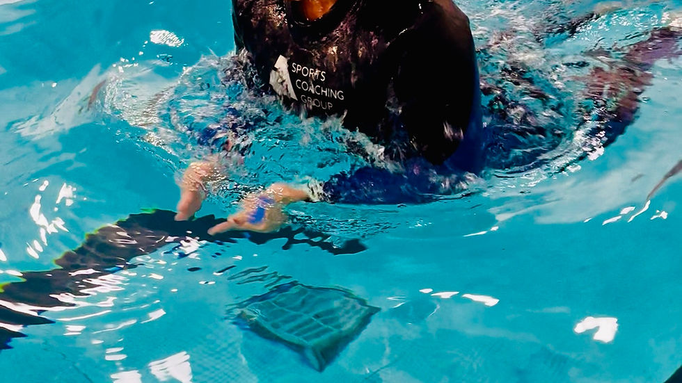 Close-up view of a swimmer practicing freestyle stroke in a pool