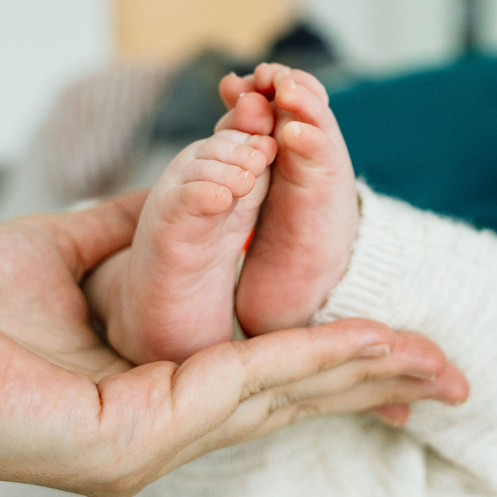 Newborn feet in hands for Osteopathy Brantford Ontario