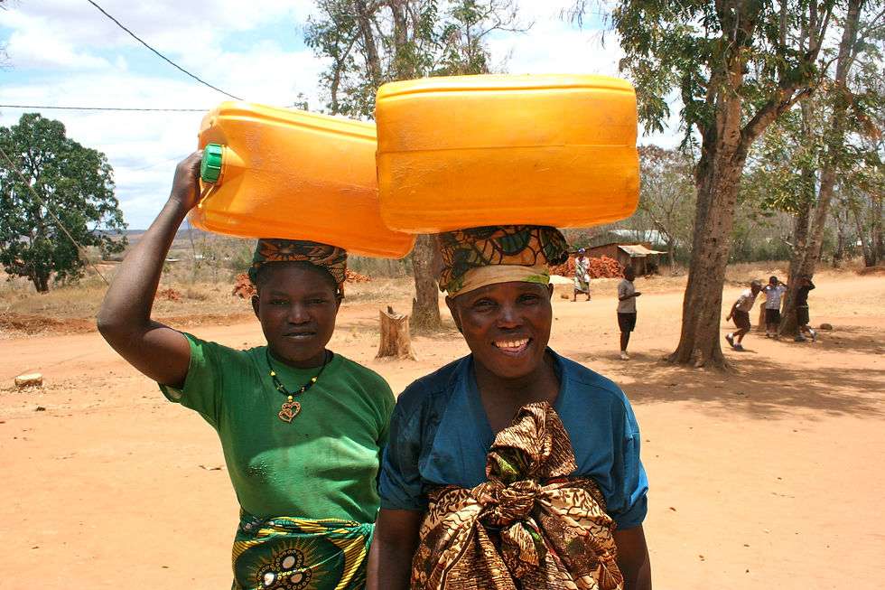 Mariam and Maria bringing water to the school.
