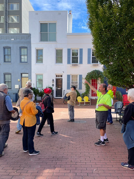 Members of the FBA "History Project "guided tour take in the history of the mews.