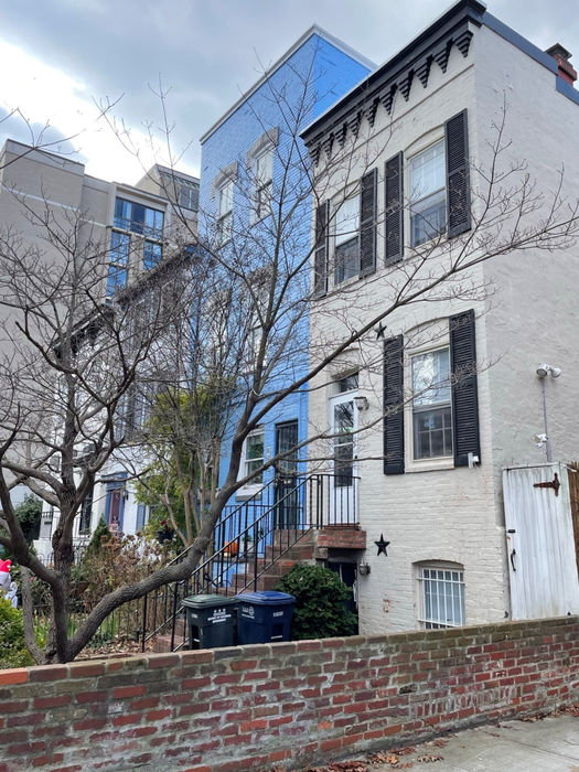 A side view of house and brick retaining wall - 828 25th St