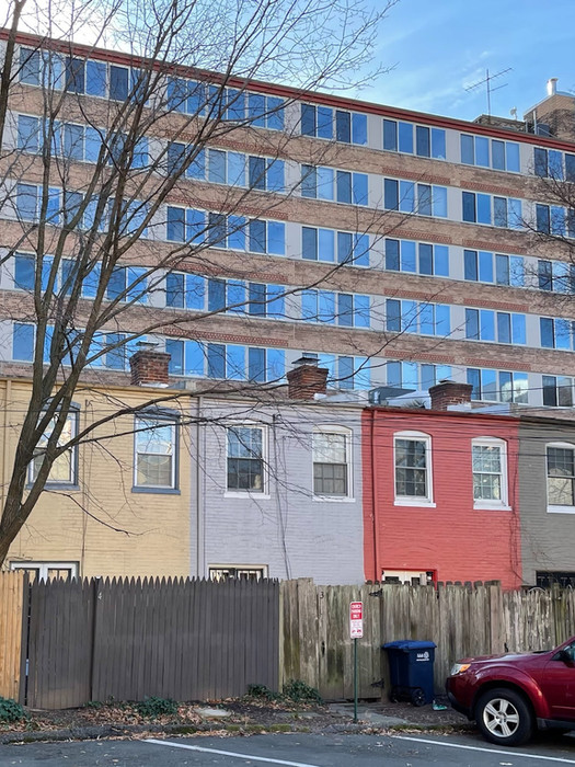 The rear facades in 2022 with the condo building rising up from behind.