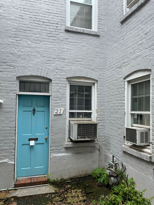 The front entry has a transom window and curved brick arch.