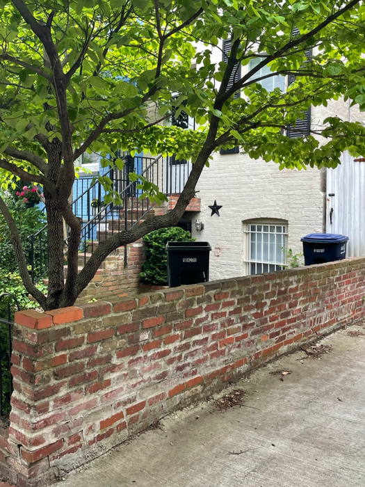 The front side retaining wall and wooden gate next to house - 828 25th St