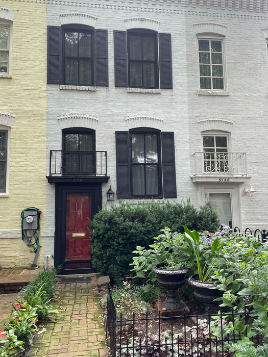 The sidewalk view with red brick entry walk.