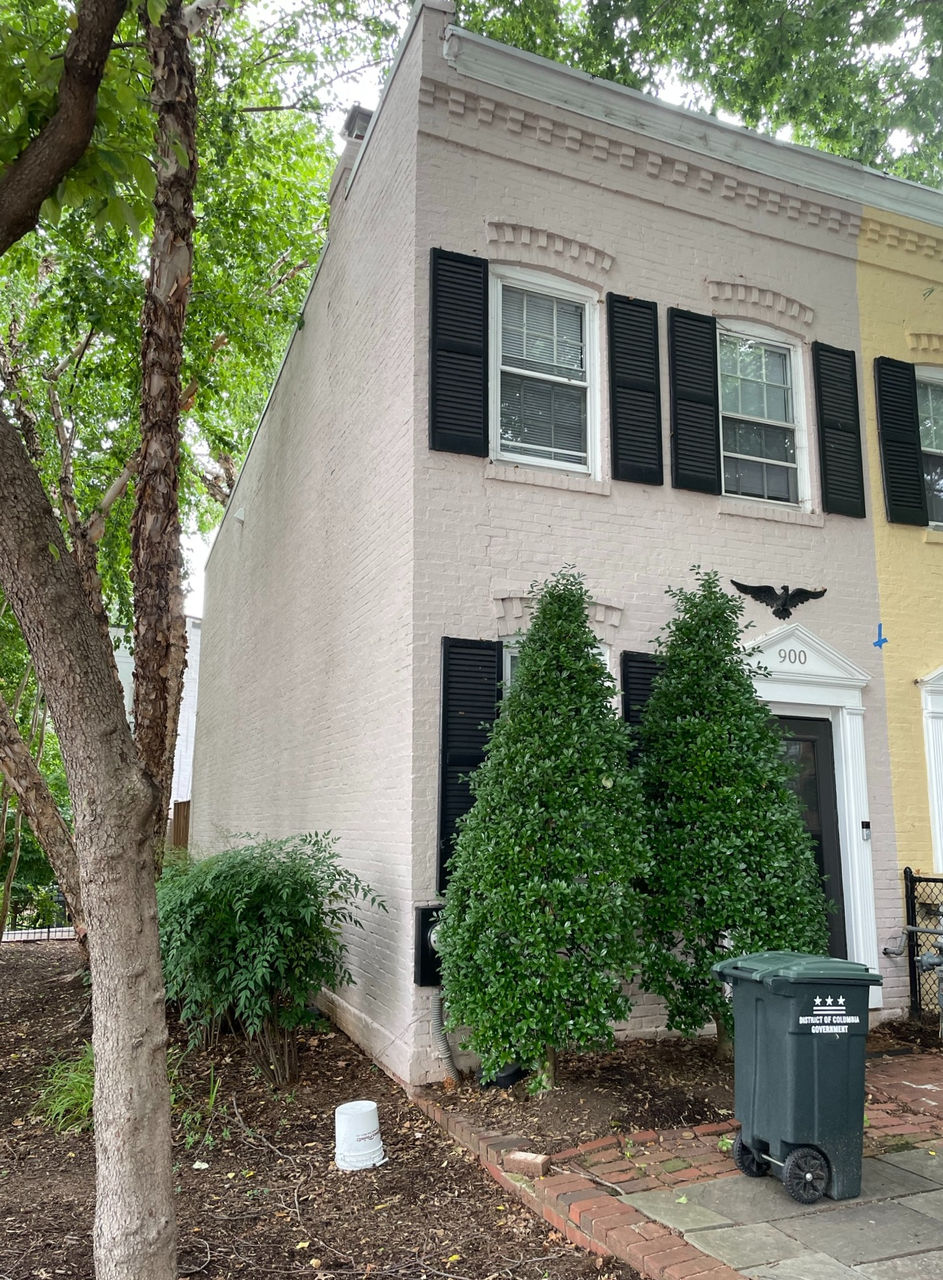 The side view of house with public property green space side lot.