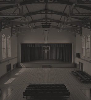 I need a photo of an older school gym that has the elevated stage at one end..jpg