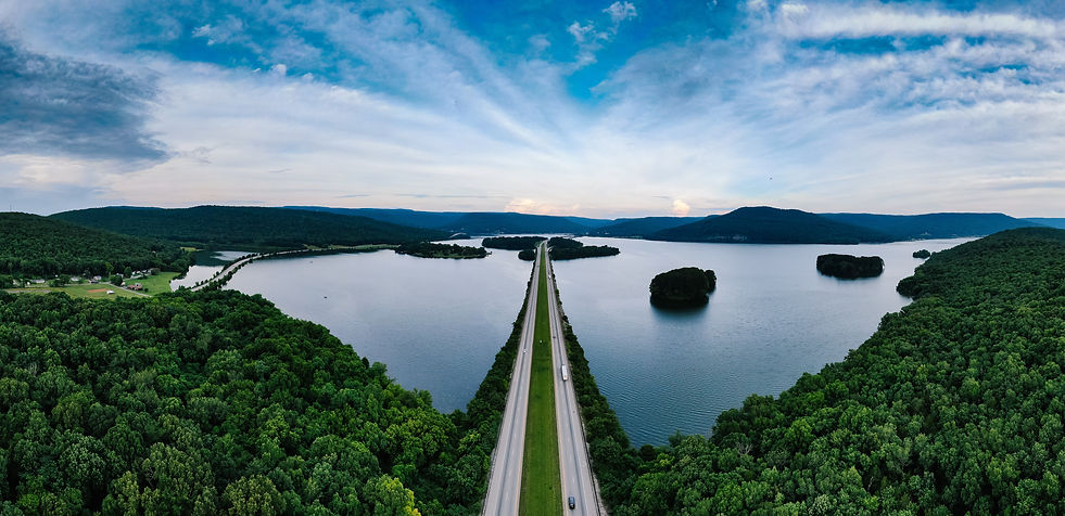Blue sky, road, and lake.