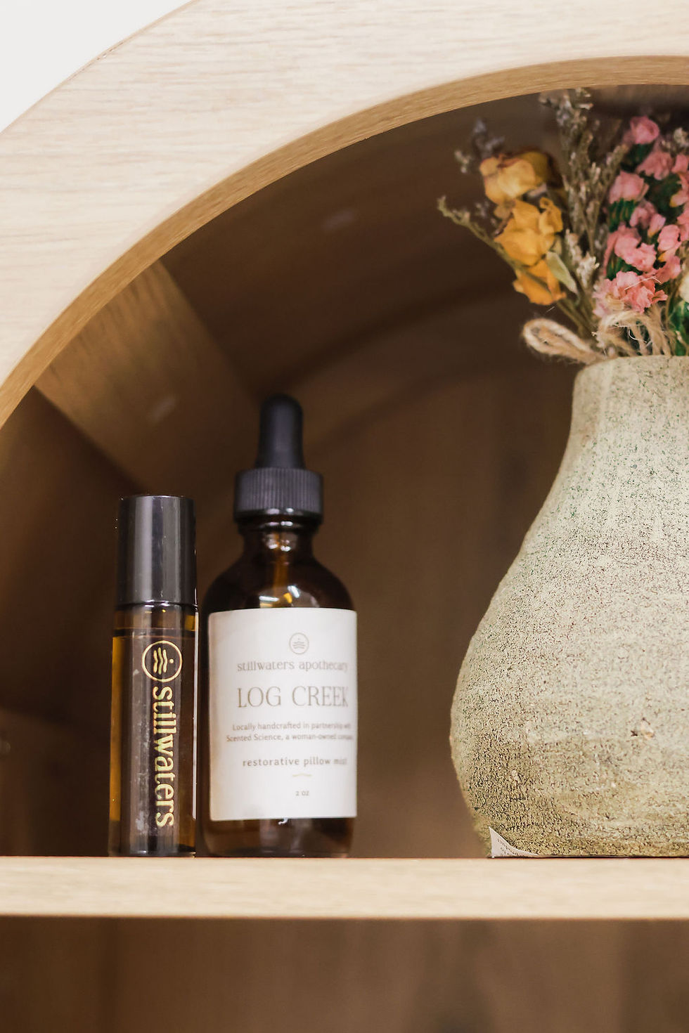 Apothecary shelf with wellness bottles and a ceramic vase, arranged in a calm setting_