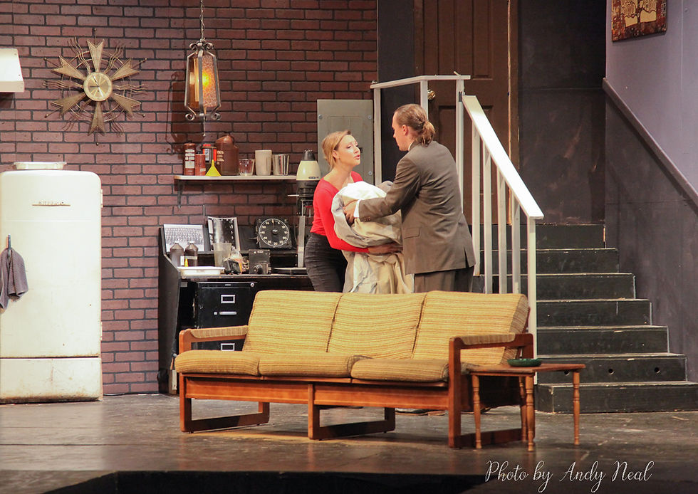 Actors performing on stage in a living room set.