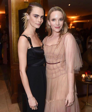 Actress Tamzin Merchant pictured with Cara Delevigne wearing pink tulle dress on the red carpet at Carnival Row Los Angeles film premiere, stylist Millie Cullum