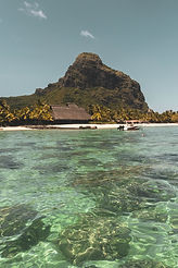 Mountain with house on the side of a beach