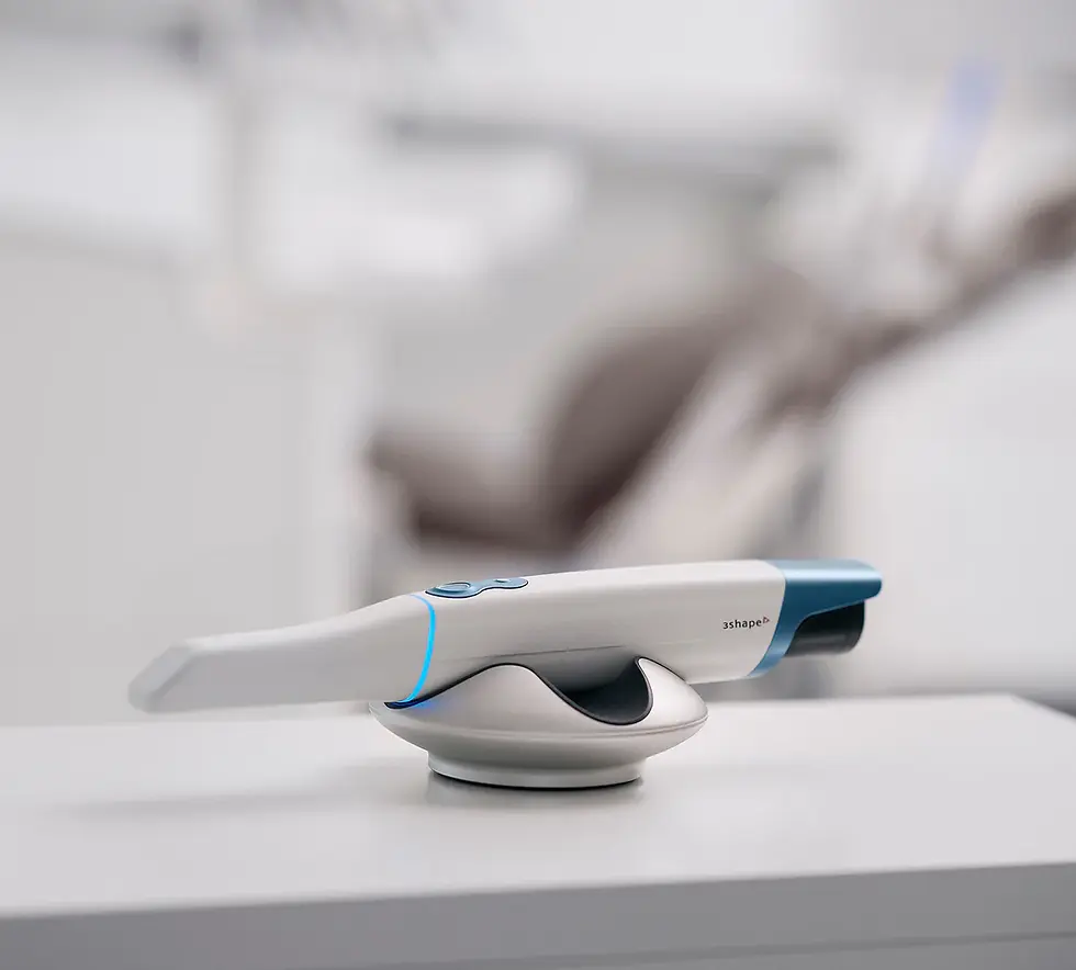 Dental scanner on a white table in a modern dental office. The scanner is sleek with blue accents, branded "3shape." Blurred background.