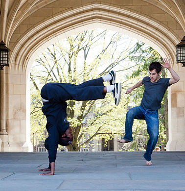 2 students playing a game in an arch