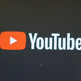 a TV _ Monitor inside a wooden frame displaying YouTube logo_edited.jpg