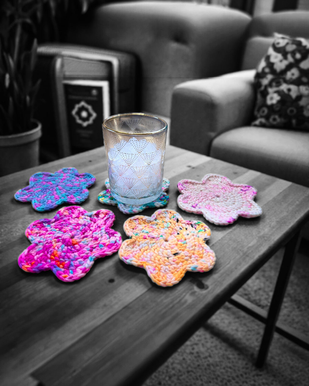 Handmade crocheted wool coasters shaped like flowers, vibrant multicolor drink coasters.