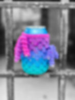 Colorful, ombre, crochet drink cozy with curly fringe, placed between metal bars. Brand tag reads "Wandering daydream".