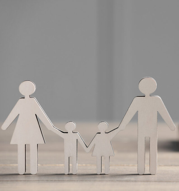 Paper family holding hands, showing united front