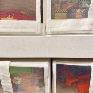 toys inside IKEA shoe bins for toy storage in kids room closet