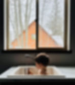 toddler playing in sink with water with North Idaho snow outside
