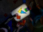 toddlers playing with magnate toys with flashlight under bin