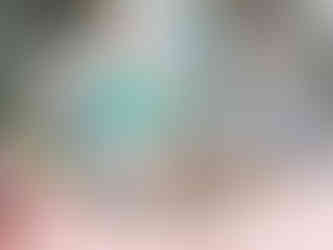 Corner building in Beyoğlu covered in overlapping graffiti tags and throw-ups in green, purple, black, and orange, creating a dense street-art collage.