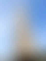 Ancient stone Obelisk of Theodosius with hieroglyphs, surrounded by ornate metal fence in Hippodrome Square, Istanbul.