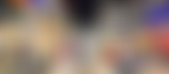 Bustling street market in Bangkok at night with food stalls, colorful signs, and people dining.