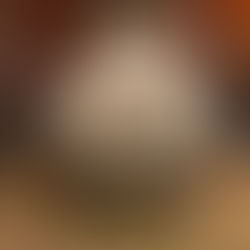 Ancient column with upside-down Medusa head in the dimly lit underground Basilica Cistern in Istanbul, surrounded by water and coins. Visitors observe.